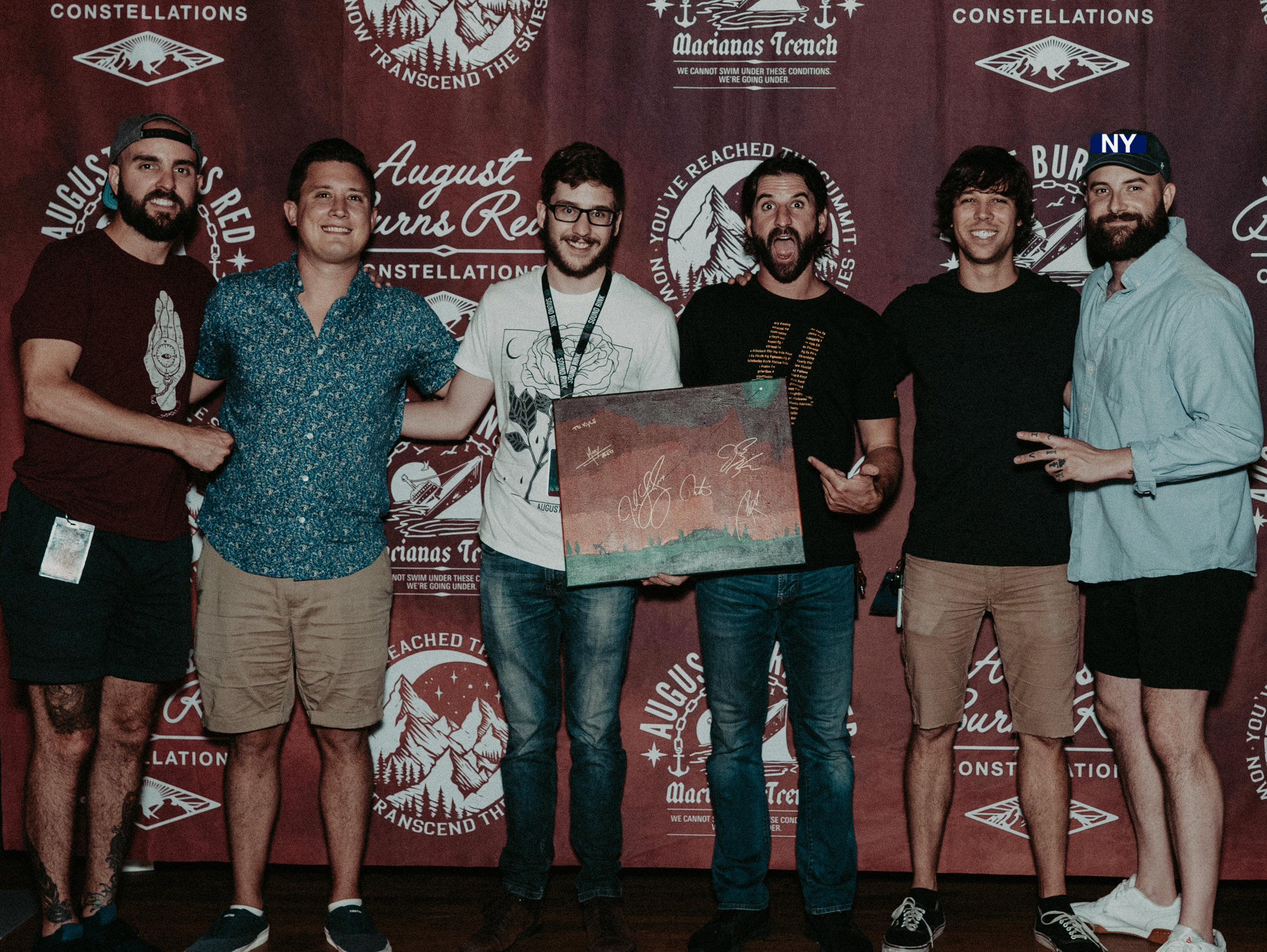 Josh standing with the members of August Burns Red.