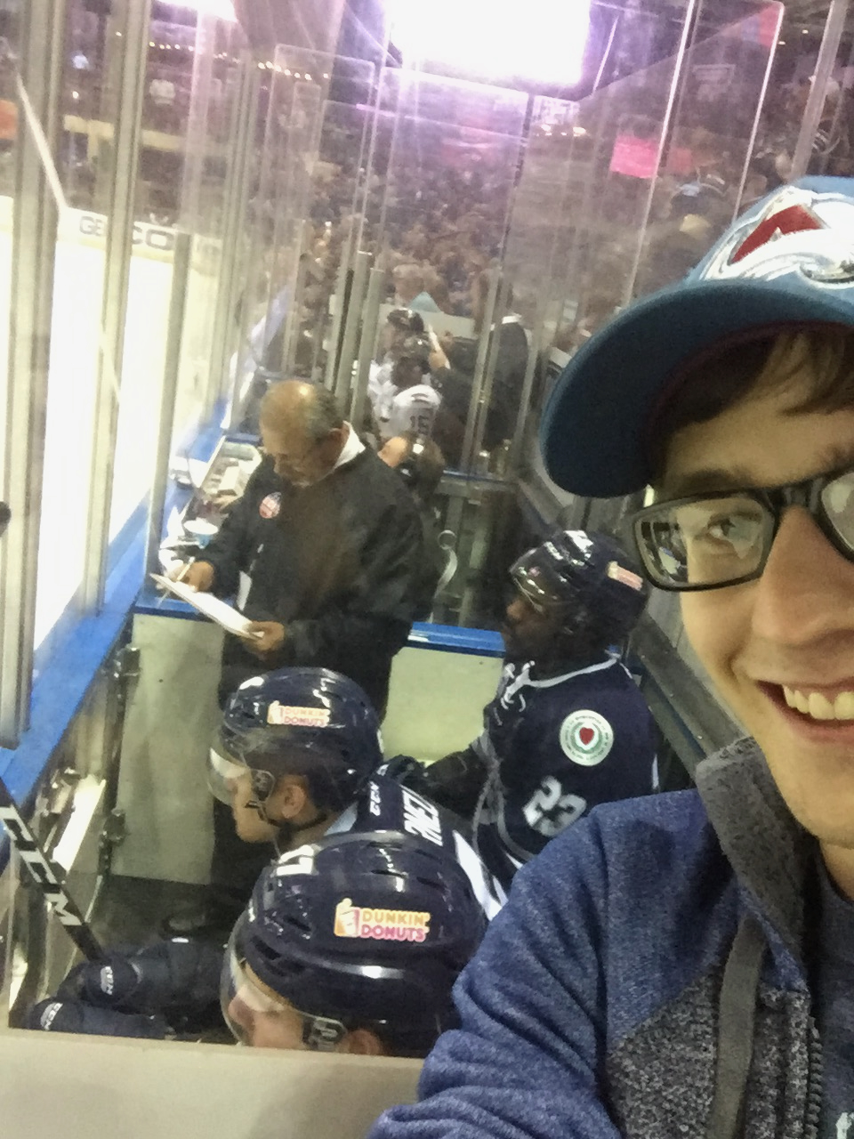 Josh poses with hockey players.